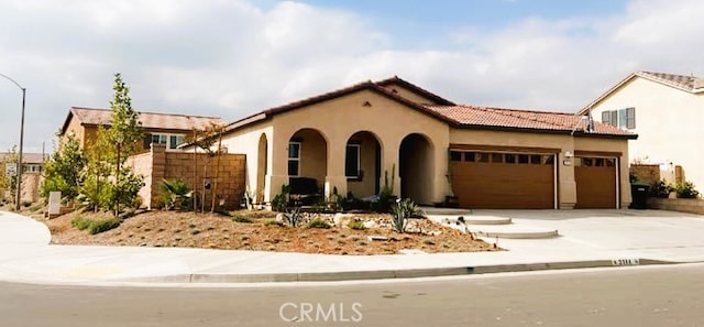 mediterranean / spanish home featuring a garage