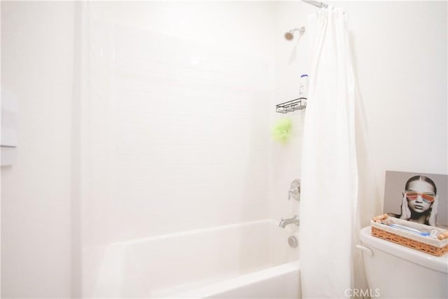 bathroom featuring shower / bath combo with shower curtain and toilet