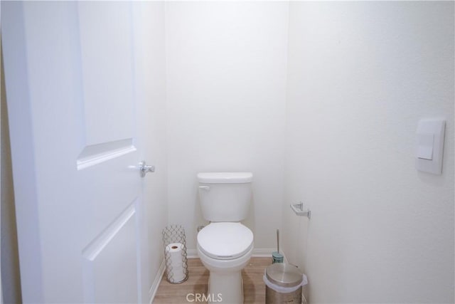 bathroom featuring hardwood / wood-style floors and toilet