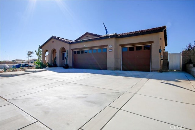 mediterranean / spanish home featuring a garage