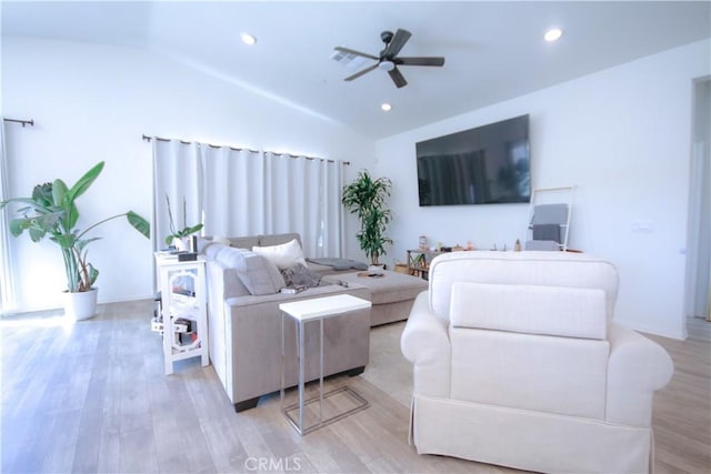 living room featuring light hardwood / wood-style floors, ceiling fan, and lofted ceiling