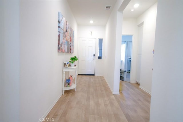 hall with light hardwood / wood-style flooring