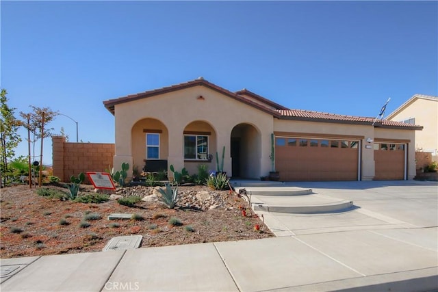 mediterranean / spanish house with a garage