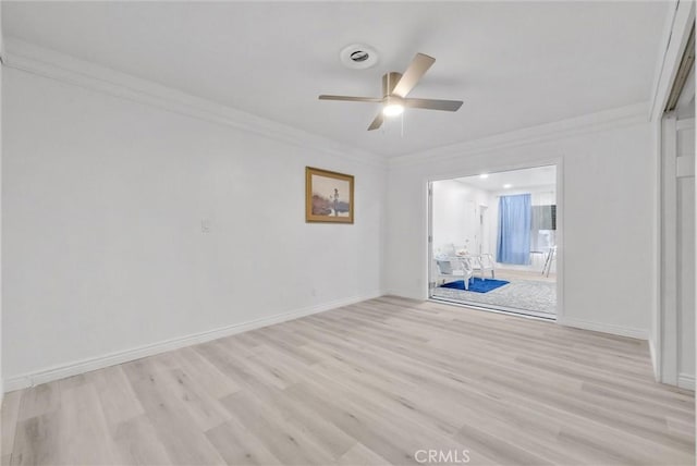 empty room with ceiling fan, light hardwood / wood-style flooring, and crown molding