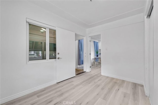 unfurnished room with light hardwood / wood-style floors