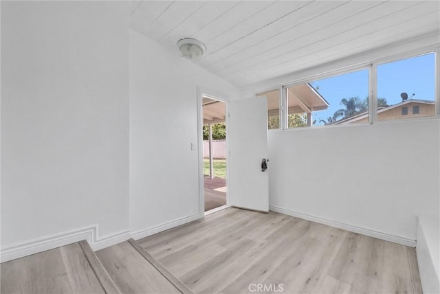 empty room featuring light hardwood / wood-style flooring and wood ceiling