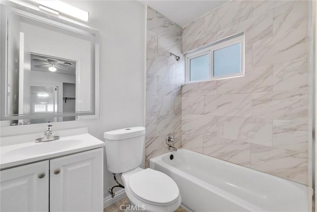 full bathroom featuring tiled shower / bath combo, toilet, and vanity