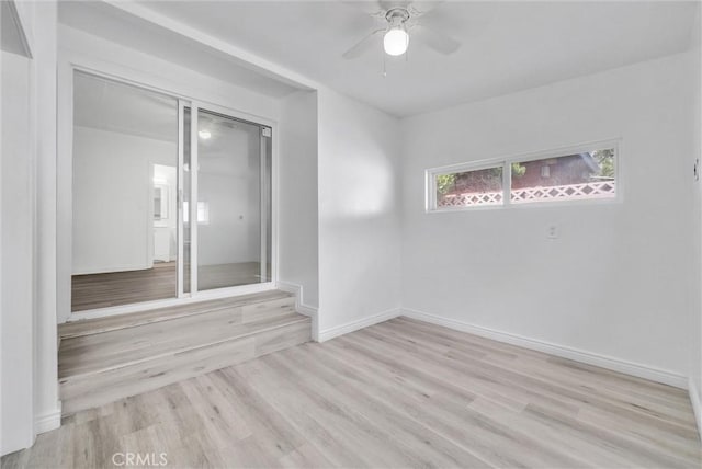 spare room with ceiling fan and light hardwood / wood-style flooring