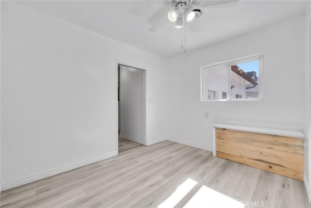 empty room featuring ceiling fan and light hardwood / wood-style floors