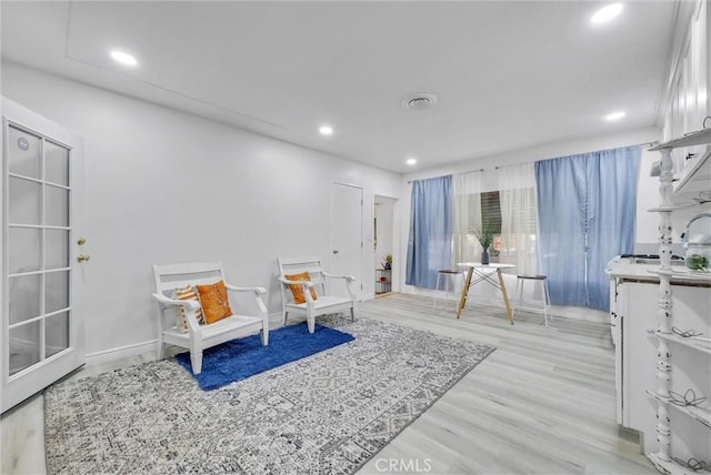 sitting room with light hardwood / wood-style floors and sink