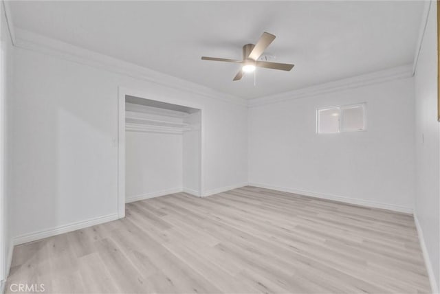 unfurnished bedroom with crown molding, ceiling fan, a closet, and light hardwood / wood-style floors