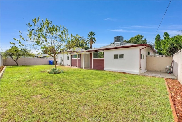 rear view of property with a yard and cooling unit