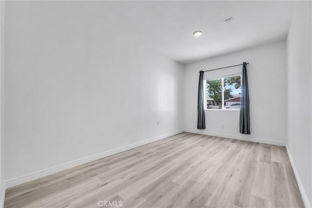 spare room with light hardwood / wood-style flooring