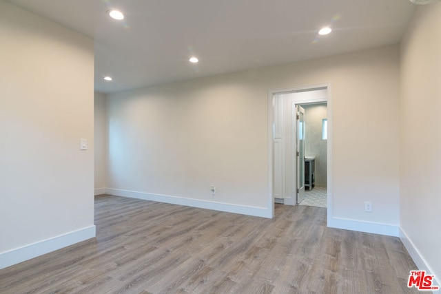 spare room featuring light hardwood / wood-style floors