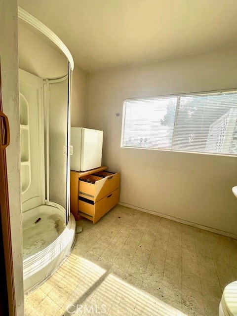 bathroom featuring toilet and a shower