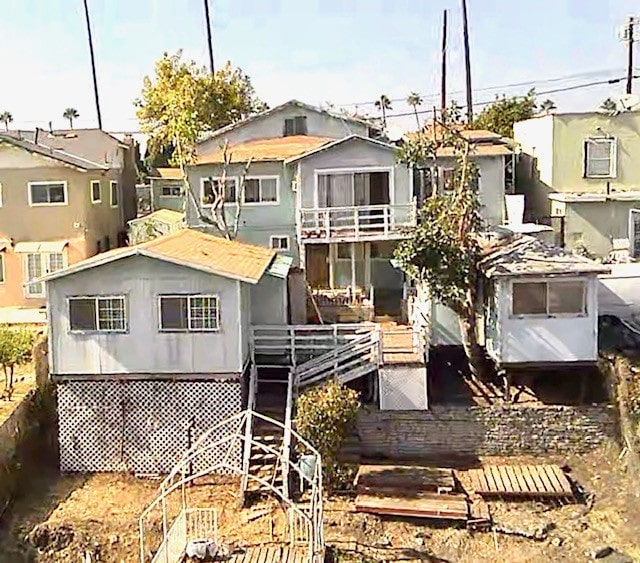 rear view of property featuring a wooden deck