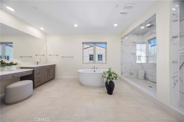 bathroom with vanity and separate shower and tub