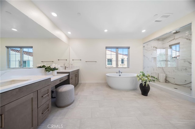 bathroom with vanity and separate shower and tub