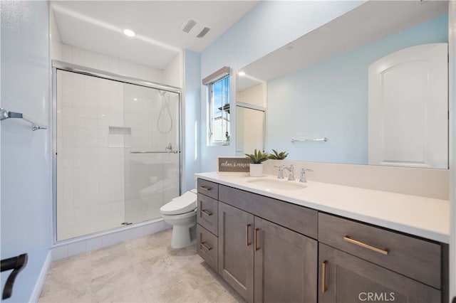 bathroom with vanity, an enclosed shower, and toilet