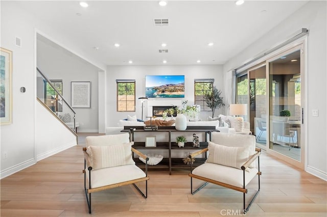 sitting room featuring a wealth of natural light and light hardwood / wood-style flooring