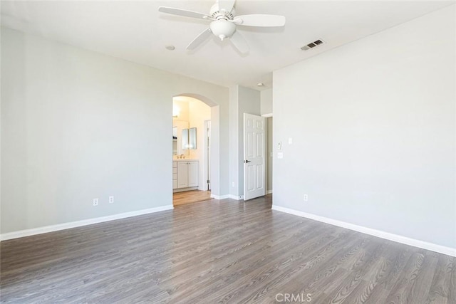 empty room featuring dark hardwood / wood-style floors and ceiling fan