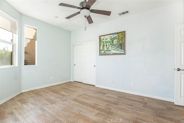 spare room featuring ceiling fan and light wood-type flooring