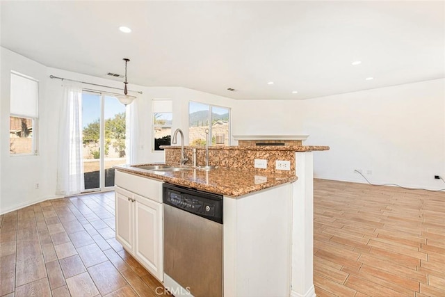 kitchen with white cabinetry, sink, stainless steel dishwasher, and light wood-type flooring