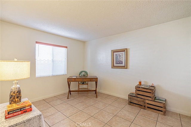 living area featuring light tile patterned flooring and a textured ceiling