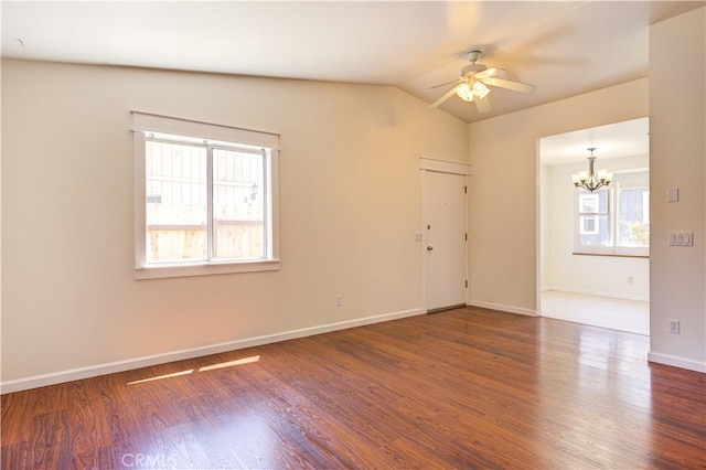 unfurnished room with vaulted ceiling, dark hardwood / wood-style flooring, and ceiling fan with notable chandelier