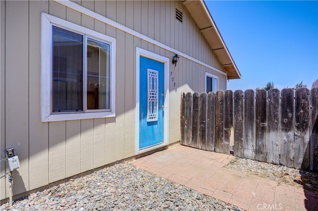 view of exterior entry featuring a patio