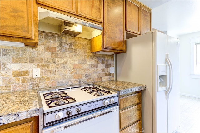 kitchen featuring white appliances and tasteful backsplash