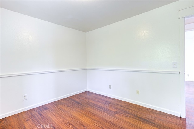 unfurnished room with wood-type flooring