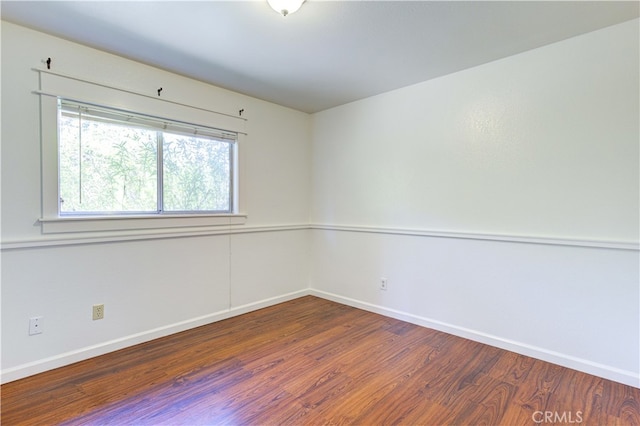 empty room with hardwood / wood-style flooring