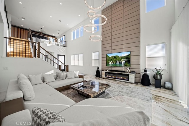 living room featuring a high ceiling and an inviting chandelier