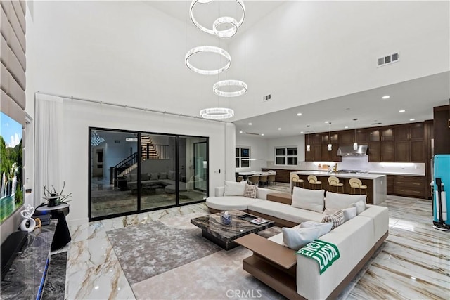 living room featuring a high ceiling and an inviting chandelier