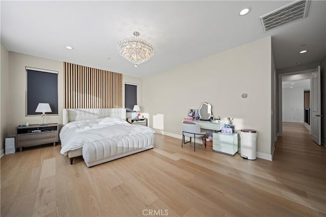 bedroom featuring a notable chandelier and light hardwood / wood-style floors