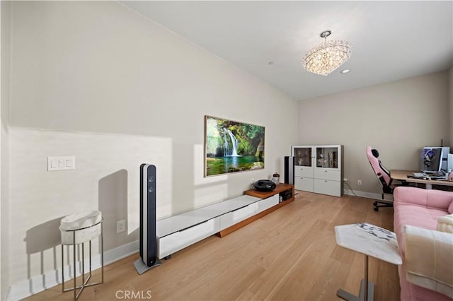 interior space with a chandelier, vaulted ceiling, and hardwood / wood-style flooring