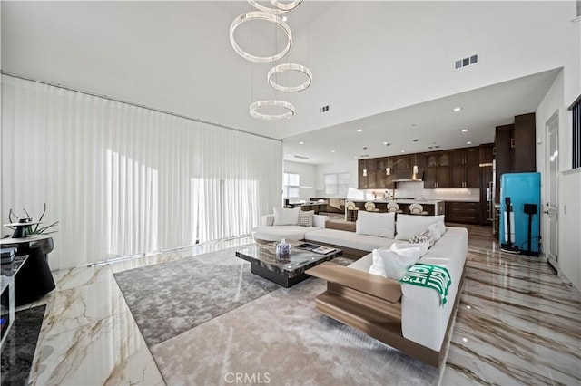 living room with a notable chandelier and a high ceiling