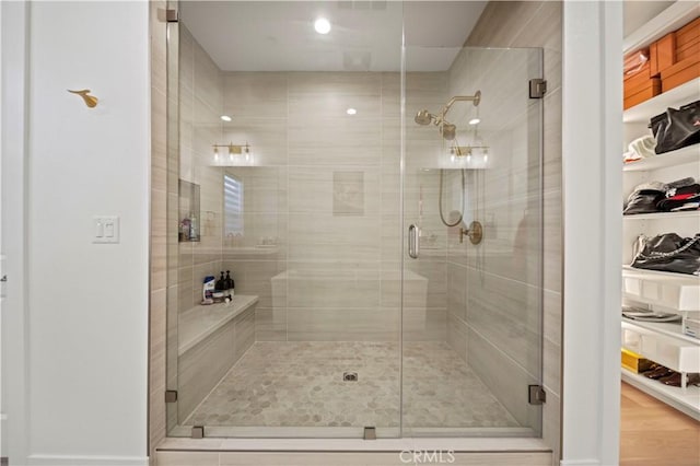 bathroom featuring hardwood / wood-style flooring and an enclosed shower