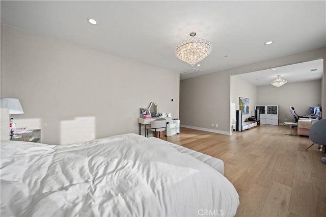 bedroom with a chandelier and light hardwood / wood-style flooring