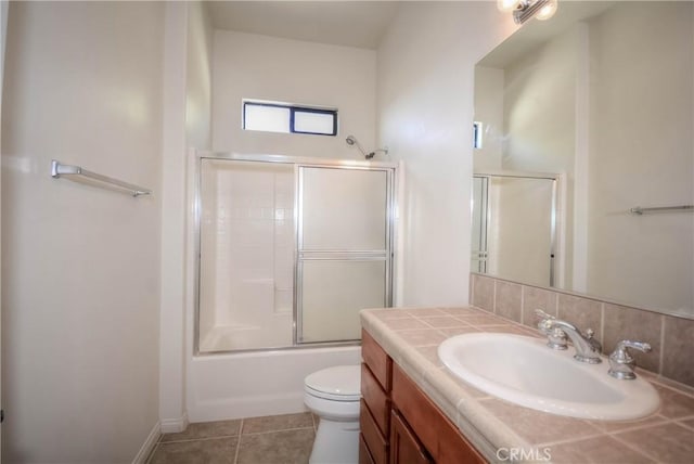 full bathroom with tile patterned flooring, vanity, toilet, and enclosed tub / shower combo