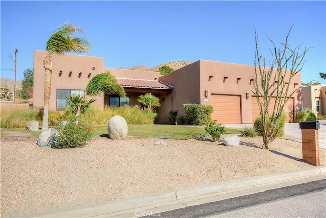 adobe home featuring a garage