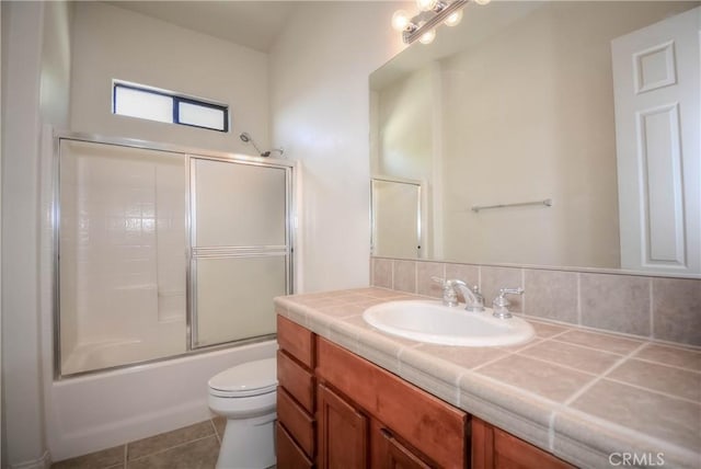 full bathroom featuring tile patterned flooring, vanity, toilet, and enclosed tub / shower combo