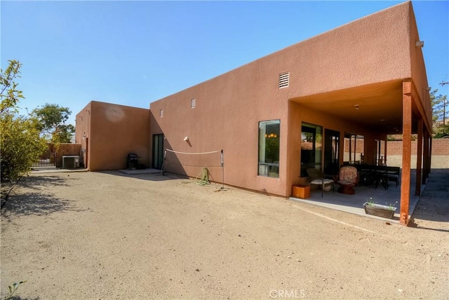 back of house featuring central air condition unit and a patio