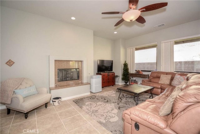 tiled living room with ceiling fan