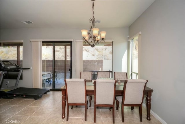 dining room with light tile patterned flooring and a chandelier