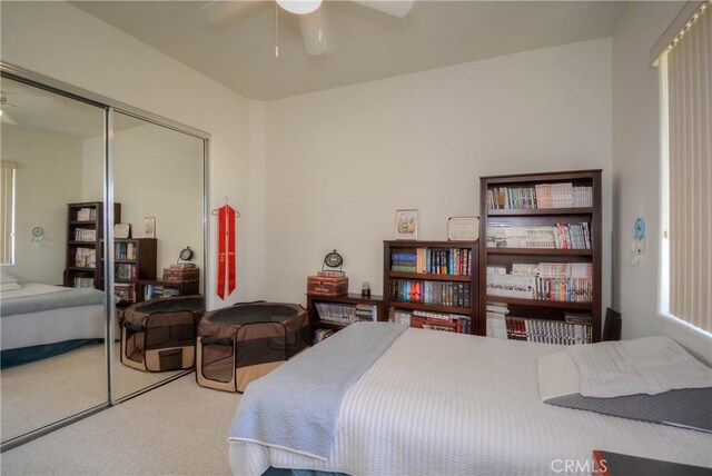 carpeted bedroom featuring a closet and ceiling fan