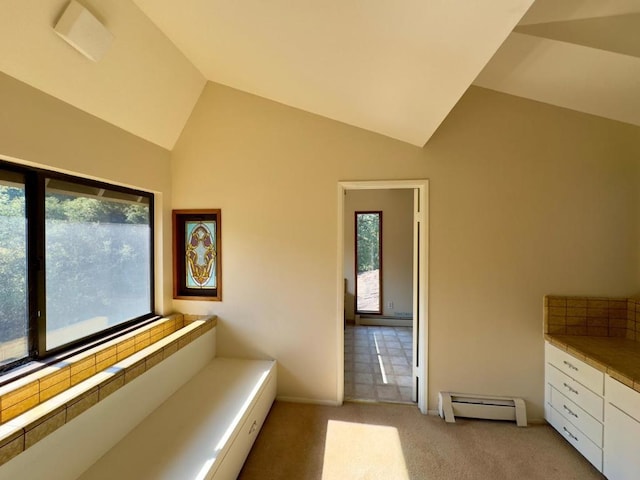 interior space with lofted ceiling, light colored carpet, and a baseboard radiator