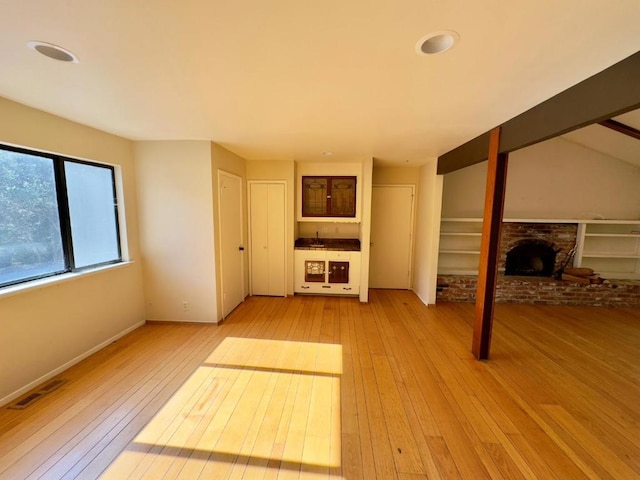 unfurnished living room featuring light hardwood / wood-style floors and a fireplace