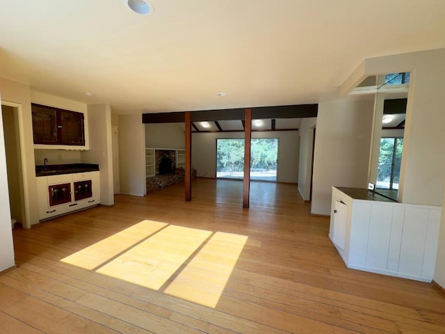 unfurnished living room featuring light hardwood / wood-style floors and sink